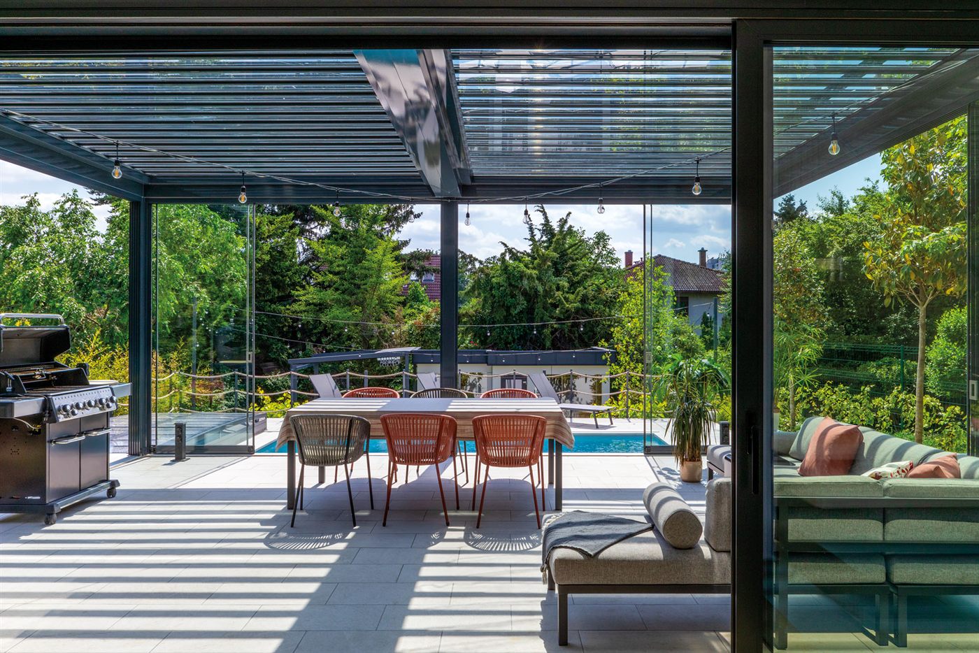 Covered terrace with outdoor dining, lounge seating, and pool