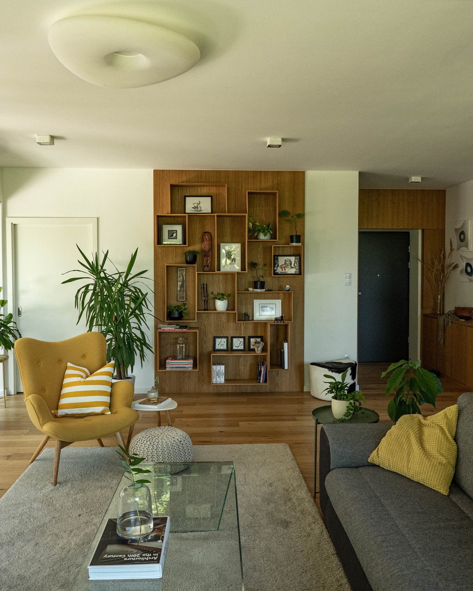 Custom geometric shelving wall displaying travel memorabilia